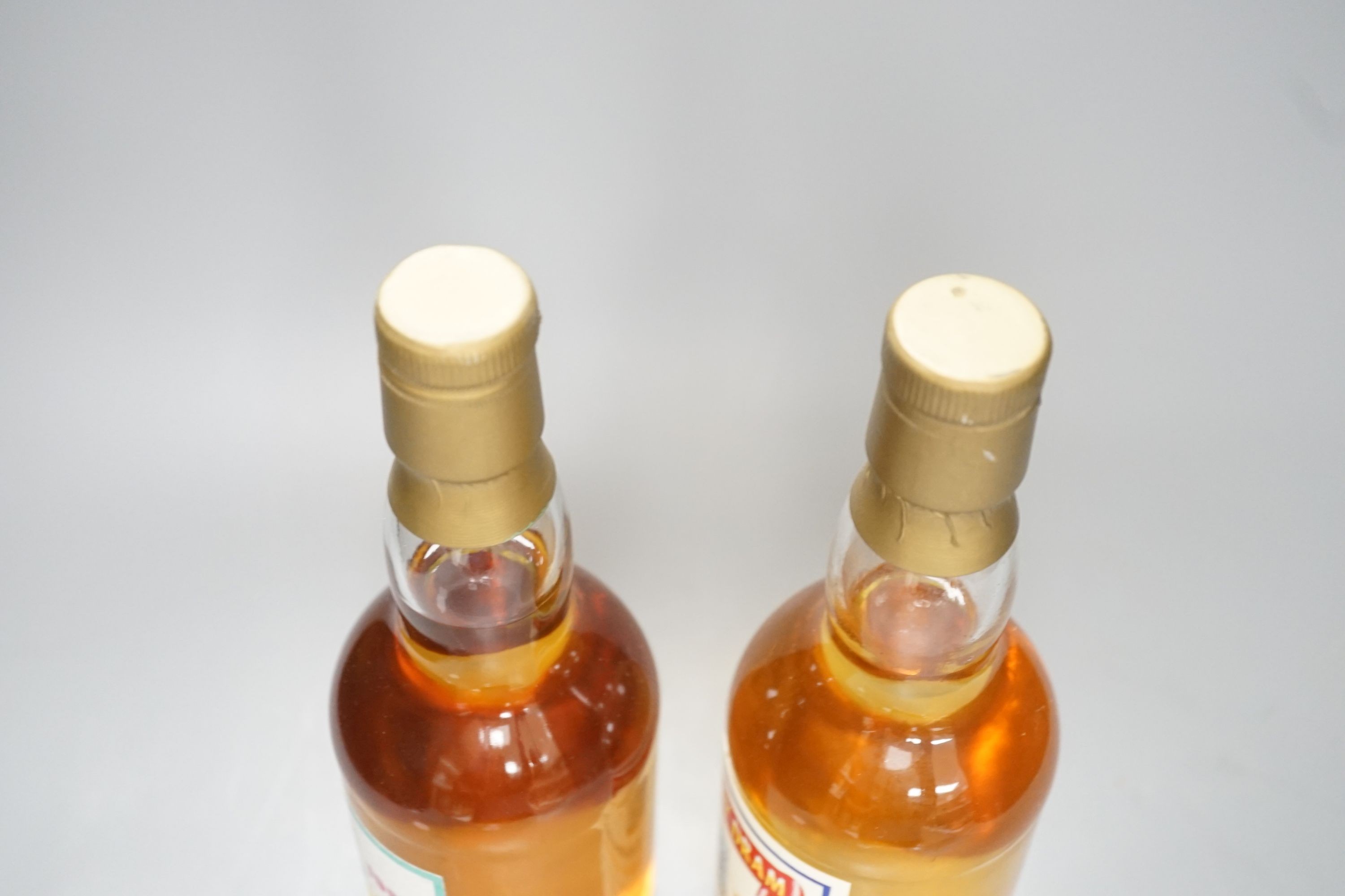 Two exclusive Master of Malt series whiskies: Hogmanay dram 1993/1994 Tomintoul 17 year old, distilled 8/10/76 bottled 12/1993 case no. 7353 bottle 29/150 and Balmenach 21 year old, bottle no. 34/60 'not to be opened unt